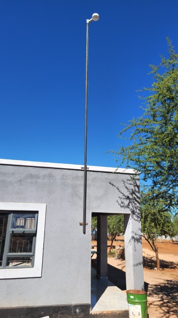Starlink dish on a tall pole mount at a rural property